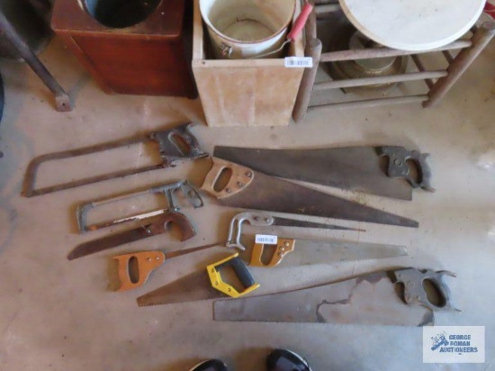 Assorted hand saws and hacksaws including miter box saw.