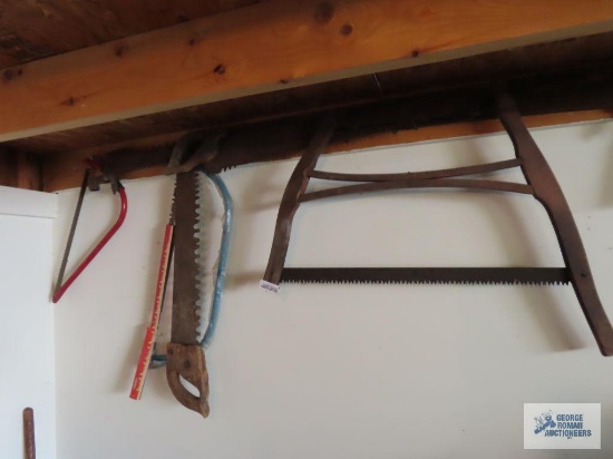 Two men saw missing handle, one man saws, and pruning saws.