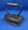 Tailors iron, cast iron, mostly black, bell picture on top of base, 