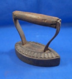 Polisher, cast iron, brownish color, fluted edging on base, wood handle, Ht 5