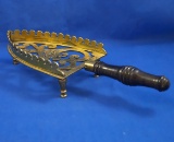 Brass iron rest, raised sides, ornamental, black wood handle, 11 1/2