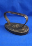 Oval Flat iron, cast iron, girl riding horse pictured on base, Ht 4