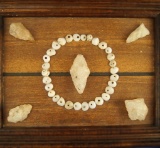 Frame including drilled shell beads and 5 quartz arrowheads collected by Ed Huss.