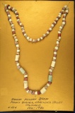 Framed strand of Spanish Mission beads; Sacramento Valley, California.
