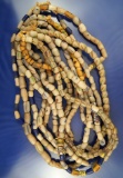 Eight strands of old sandcast glass beads, all around 24