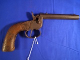 Flobert .22 caliber Single Shot Pistol with some age damage to grip.