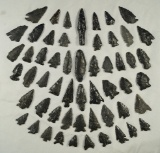 Group of obsidian artifacts found in Fort Rock Oregon which are glued to a board.