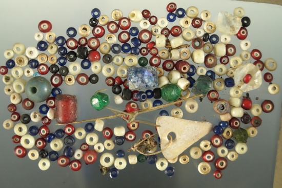 Group/bag of assorted small trade beads found in various locations.