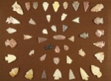 Large group of 40+ assorted arrowheads found in the Kansas area glued to a board.