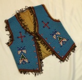 Elaborate Sioux Beaded Childs Vest with gold fringe and beadwork. Circa early 1900's