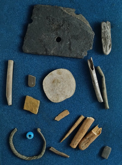 Group of assorted artifacts found near the Columbia River including bone, stone and trade beads. Lar