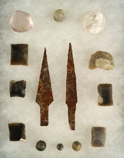 Group of historic era artifacts including gunflints, metal projectile points and spent musket balls.