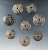 Set of eight highly decorated clay spindle whorls from Mexico.