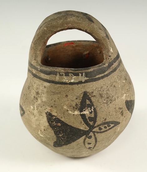 4" tall by 3 1/4" wide strap handled pottery vessel from Arizona with original paint.