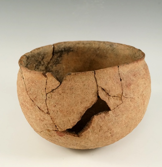 5" wide by 3 1/2" tall Mississippian shell tempered pottery vessel with some pieces glued back.