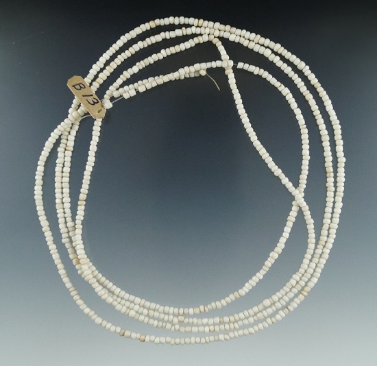 59 1/2" strand of white seed beads found in New York.
