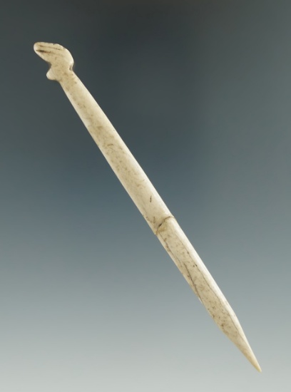 4 7/16" stylized bone awl that is broken and glued at the midsection.