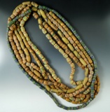 Six strands of colorful sand-cast beads. Each strand is a different color pattern.