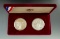 1983 & 1984 Olympiad Two Coin Silver Proof Sets with papers.
