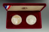 1983 & 1984 Olympiad Two Coin Silver Proof Sets with papers.