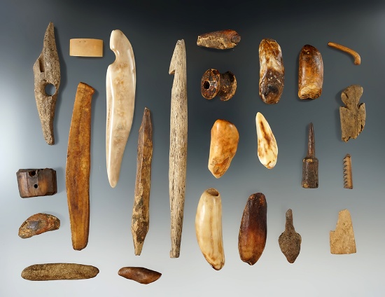 Group of 24 assorted bone artifacts found in Alaska, largest is a 5 3/8" harpoon tip.