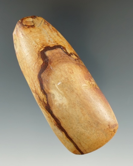 3 5/8" Celt made from tan and brown Petrified Wood, found in Arkansas. Ex. Charles Shewey.