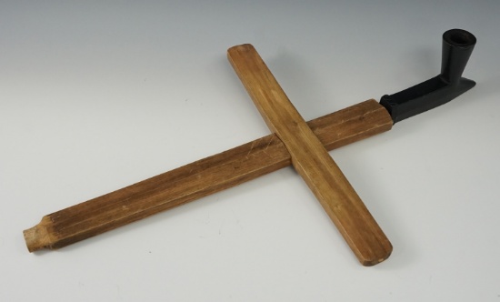 Unique Ojibway pipe made from black pipestone with a wooden cross stem. Manitoba, Canada.