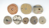 Group of eight Prehistoric pottery shards that were salvaged into discs. All are perforated.