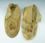 Pair of early 1900's Floral design leather Moccasins. One has a few small holes near toe area.