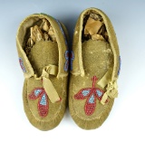 Pair of nicely beaded Floral Design Childs Moccasins that measure 5 3/4
