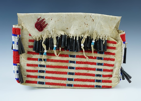Cheyenne beaded leather bag with flap top featuring a striped beaded pattern. Early 1900's.