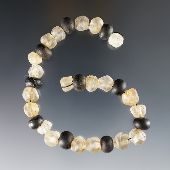 9 1/2" Strand of black Round and clear Faceted Wire Wound Beads. Geneva, New York.