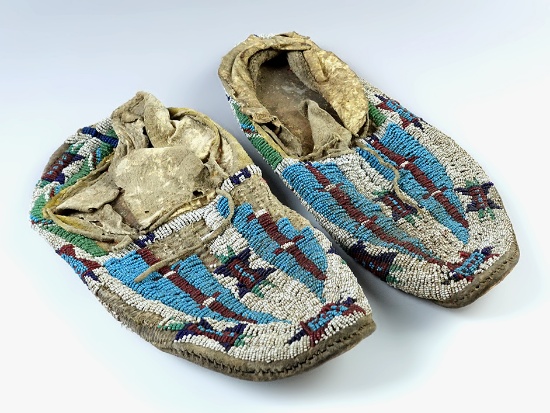 Pair of 9 1/2" long Beaded Leather Moccasins, both have some bead loss. Leather has hardened.