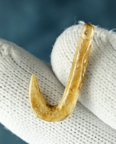 1" fine Kentucky Fish Hook made from patinated Bone. Was once glued to a board.