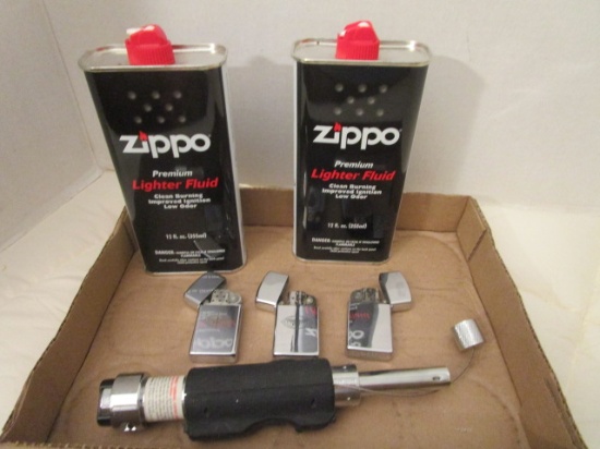 Zippo Large Lighter, Three Small Lighters, and Zippo Lighter Fluid