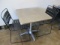 Table and Two Metal Chairs