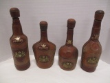 Four Leather Covered Whiskey Bottles with Crests