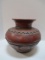 Carved Clay Vessel With Notched Detailing And Floral Band