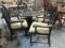 Black Base Beveled Glass Top Table and Four Rolling Arm Chairs with Upholstered Seats