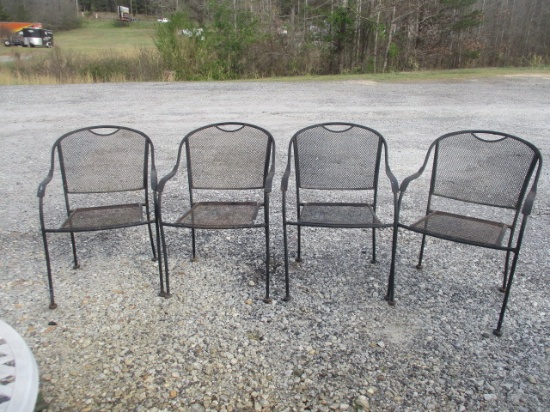 Four Black Metal Mesh Stacking Arm Chairs