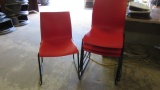 Four Teknion Red Nami Stacking Chairs