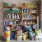 Contents of Two Garage Shelf Units-Plant Food, Paints, Gardening Tools,
