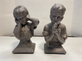 Boy Playing Horn and Girl Holding Ears Statues.