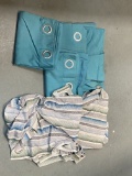 Tow Pair of Teal Grommet Curtains and One St of Multi Colored Grommet Curtains.