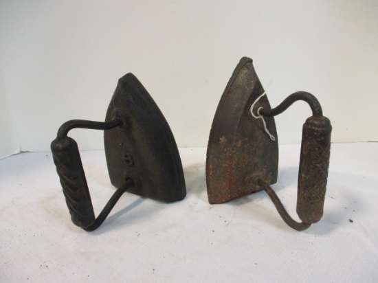Two Cast Iron Sad Irons with Handles. On Top Number 6 and 6 with Star.