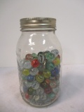 Ball Mason Jar Over Half Full of Marbles.