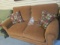 Bassett Rust Colored Loveseat with Nail Head Trim and Pair of of Pillows. Very Good Condition.