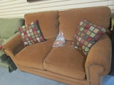 Bassett Rust Colored Loveseat with Nail Head Trim and Pair of of Pillows. Very Good Condition.