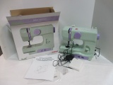 Janome Portable New Home Sewing Machine, In Original Box, Appears Unused.
