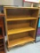 Three Shelf Oak Bookcase with Adjustable Shelves and Decorative Bottom and Legs.